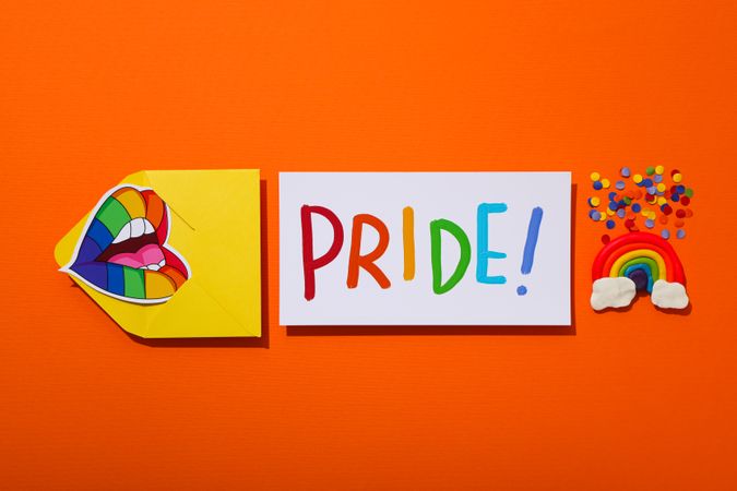 Pride parade concept, symbols on orange background.