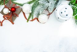 Christmas frame of decorations on snowy background