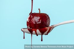 Baked apple covered in red wine sauce isolated on a blue background bYQP1b