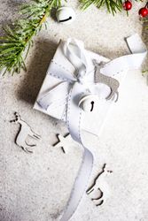 Christmas scene of gift with reindeer and star ornament on concrete background