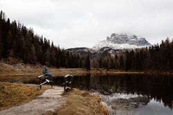 Woman delighting in views near lake and mountains