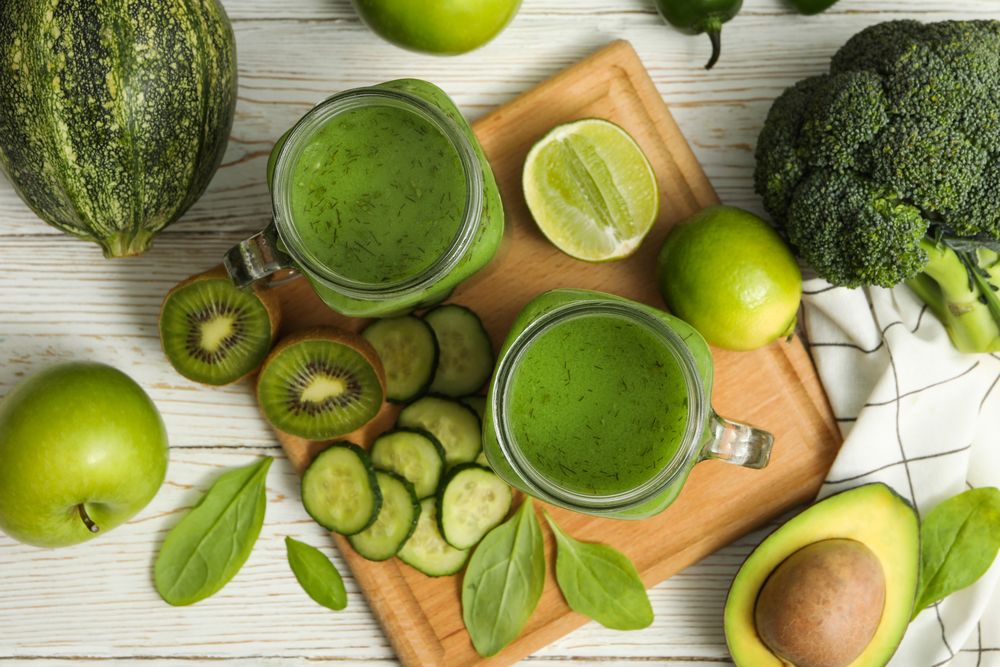 Concept of healthy food with smoothie, vegetables and fruits on wooden table