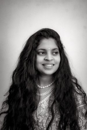 Portrait of an Indian woman smiling in grayscale