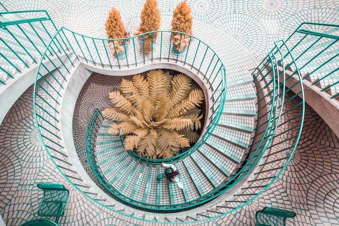 Aerial view of person getting down green spiral stair