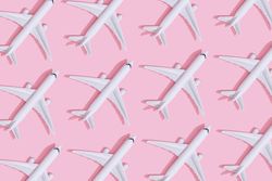 Passenger plane pattern on pastel pink background