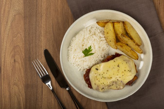 Parmigiana steak with rice and roasted potatoes. Typical Brazilian dish.
