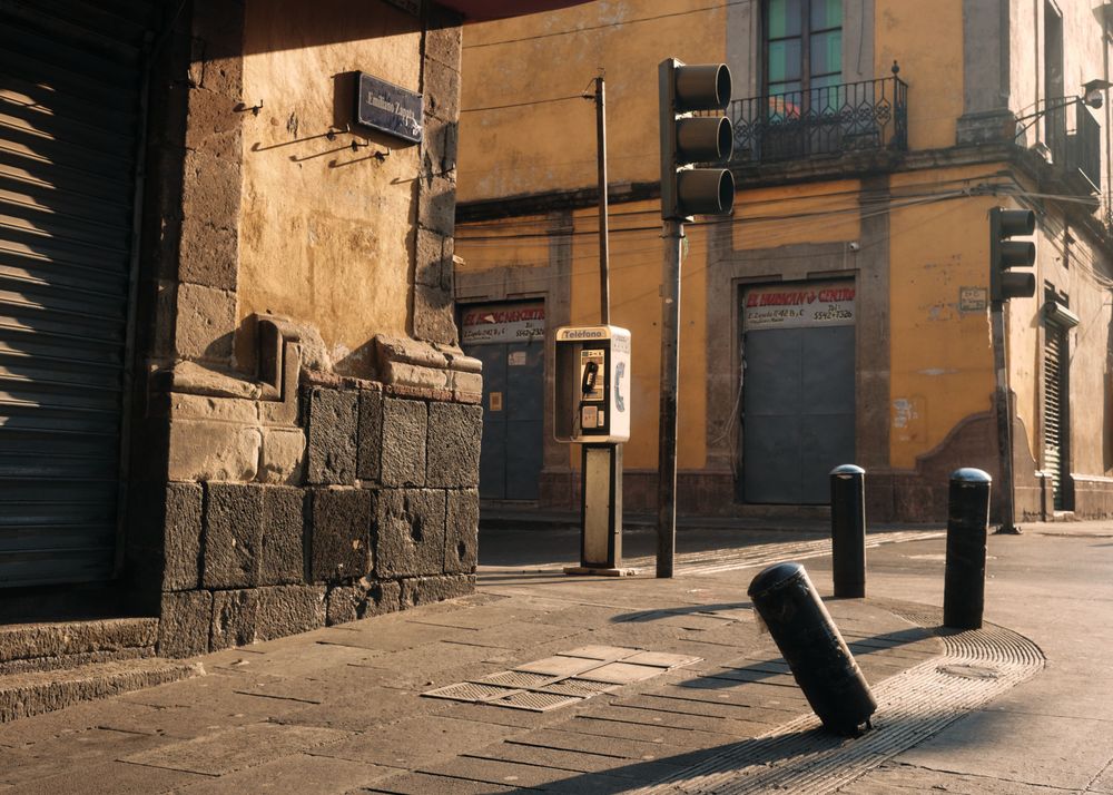 Phone booth in empty street in Mexico City