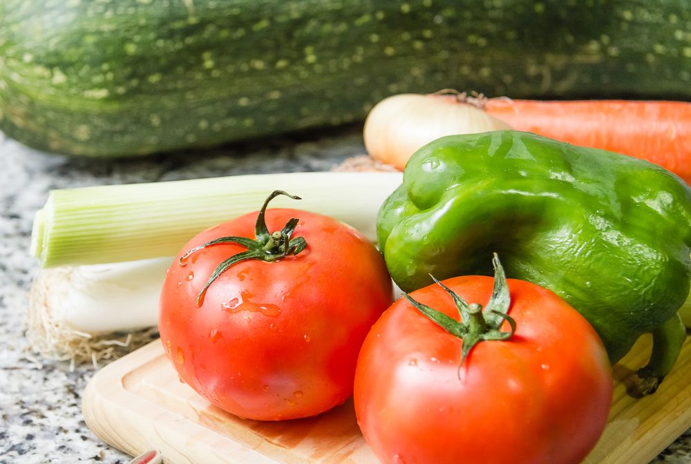 Fresh vegetables on cutting board in the kitchen