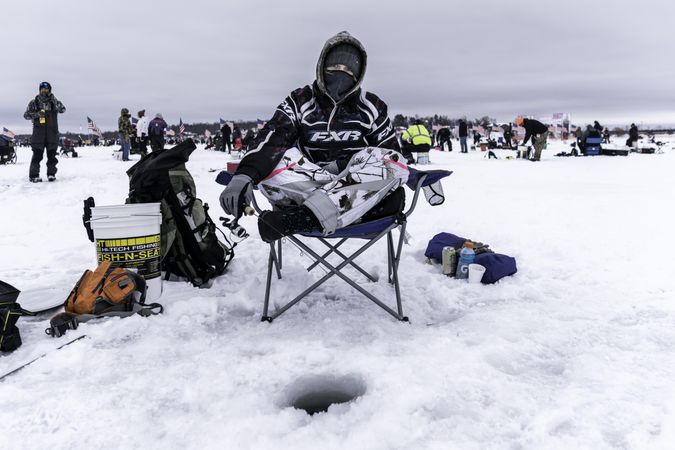 Nisswa, MN, USA - January 25th, 2020: A female competitor at an ice fishing tournament