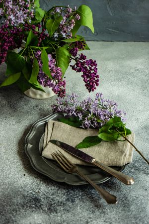 Spring table setting with lilacs on rustic napkin
