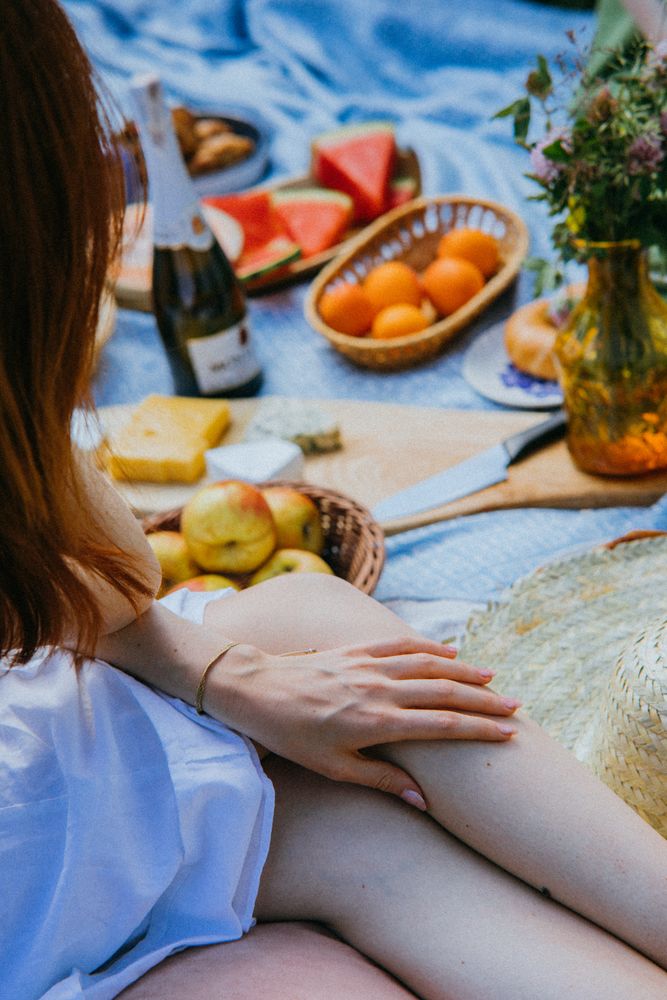 Woman sitting beside picnic set
