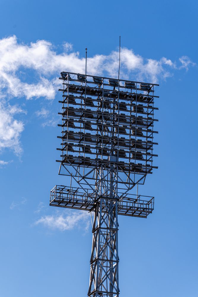 Stadium lights on the blue sky background