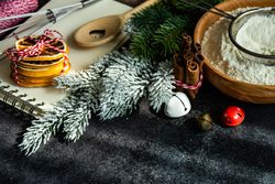 Flour and ingredients for Christmas baking on dark counter