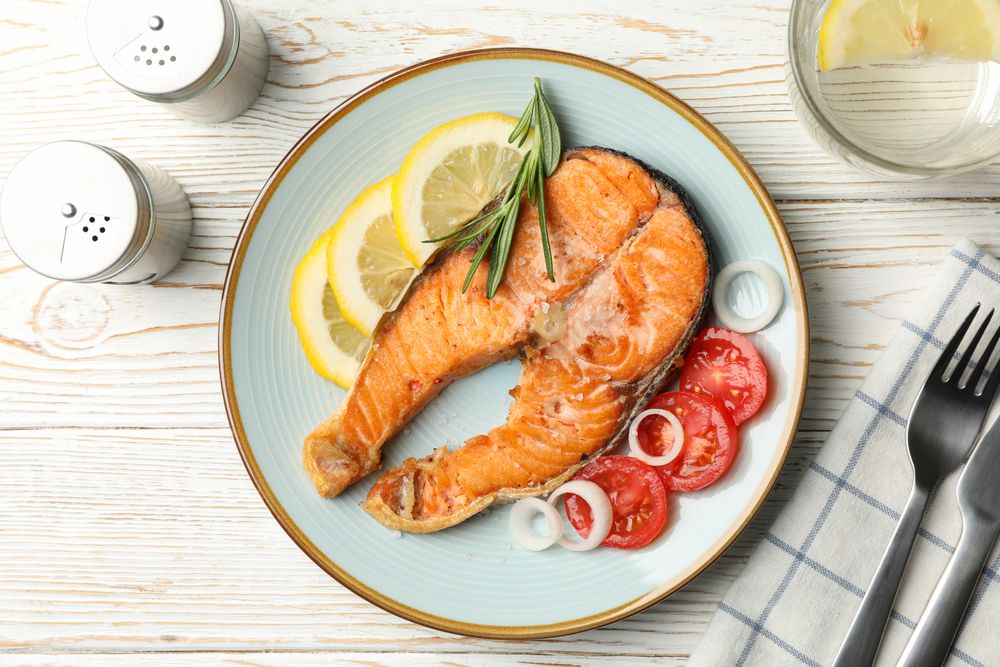 Composition with tasty grilled salmon on wooden background, top view