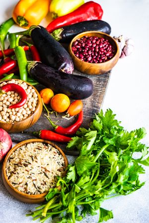 Fresh vegetables and grains on cutting board with copy space