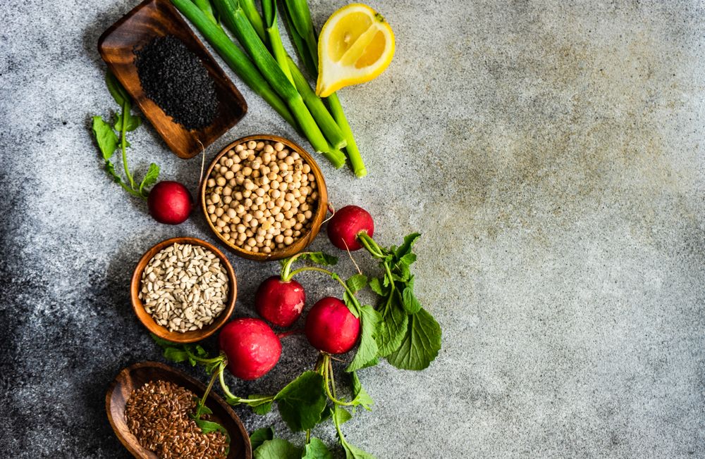 Fresh ingredients of radishes, lemon slices and chick peas with copy space