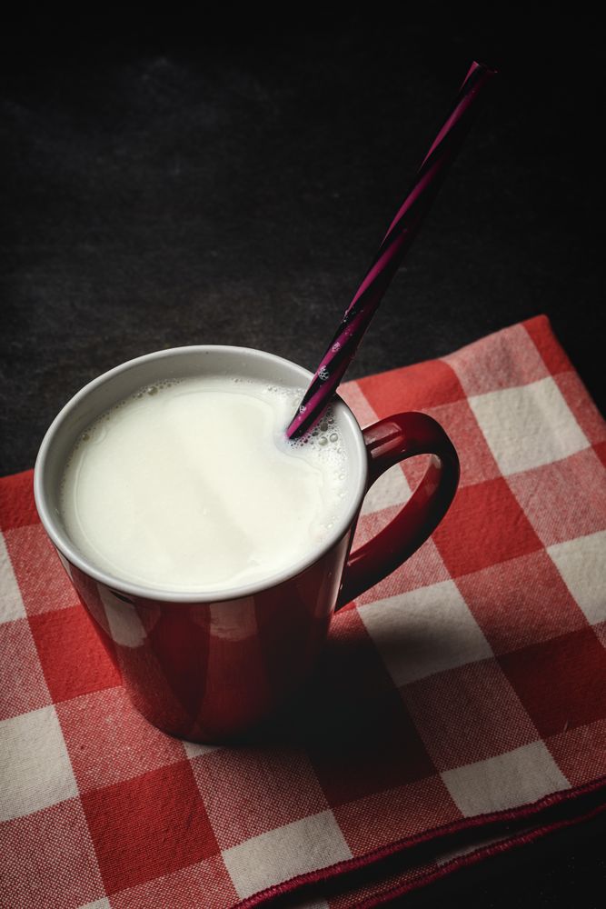 Cup of milk on table