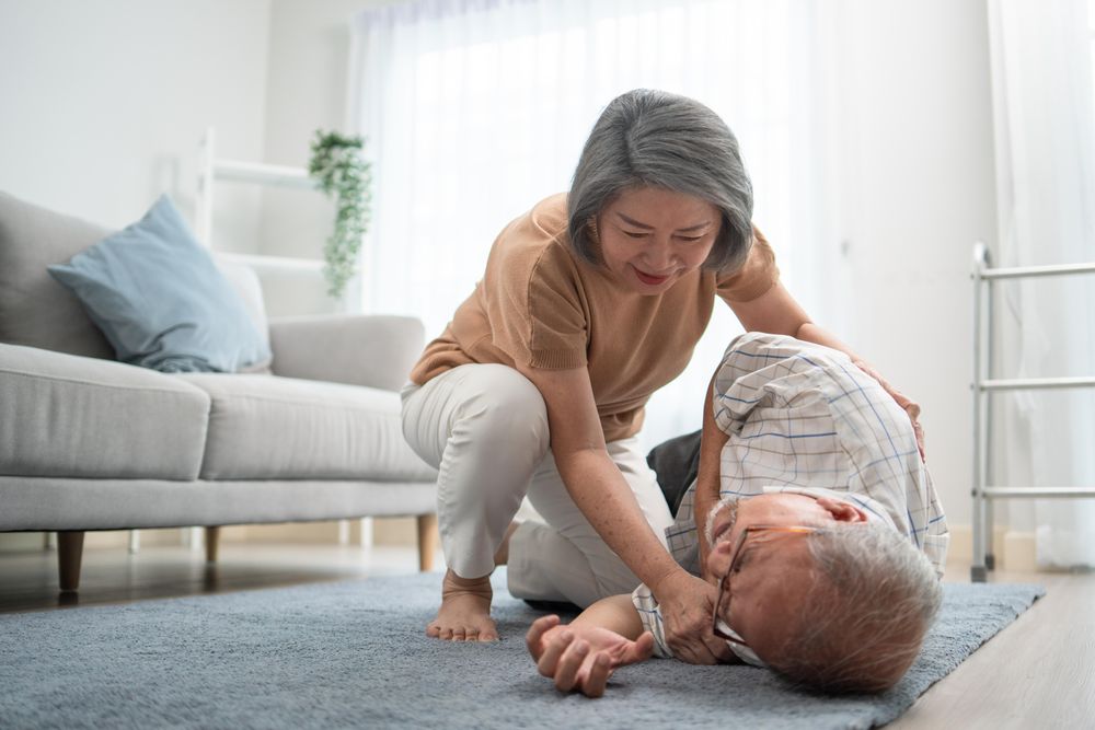 Older male patient lying on ground after falling over