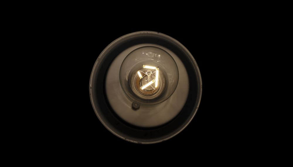 Traditional vintage transparent single light bulb in lamp container