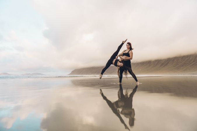 Women exercising near sea