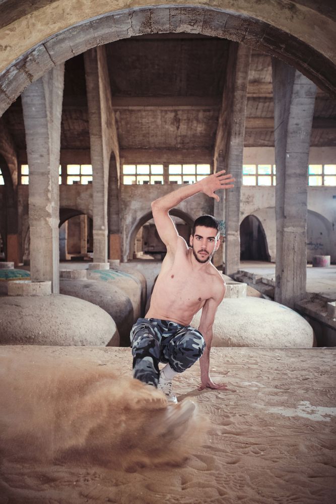 Guy during break dance in dusty cathedral