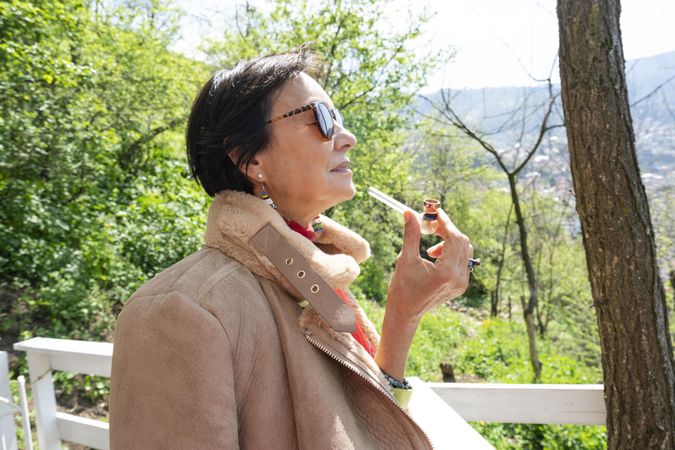 Side view of mature woman with marijuana pipe