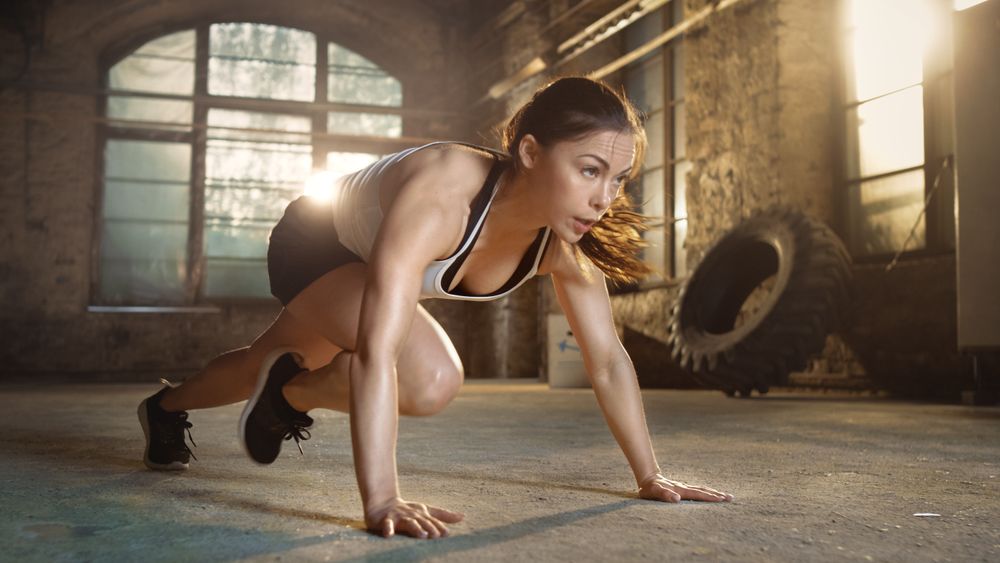 Athletic Woman Does Running Plank as Part of Her Cross Fitness