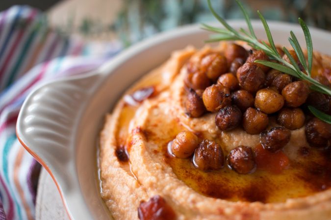 Rosemary sprig on pepper hummus