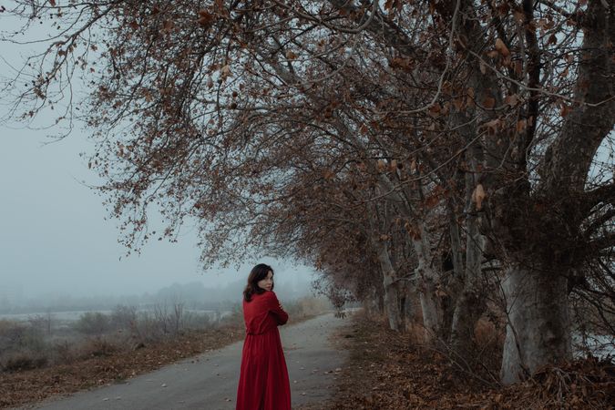 Woman in red dress walking in foggy area