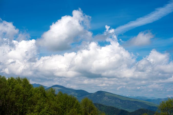 Mountain range beneath a partly cloudy sky.