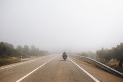 Motorcyclist riding into the fog