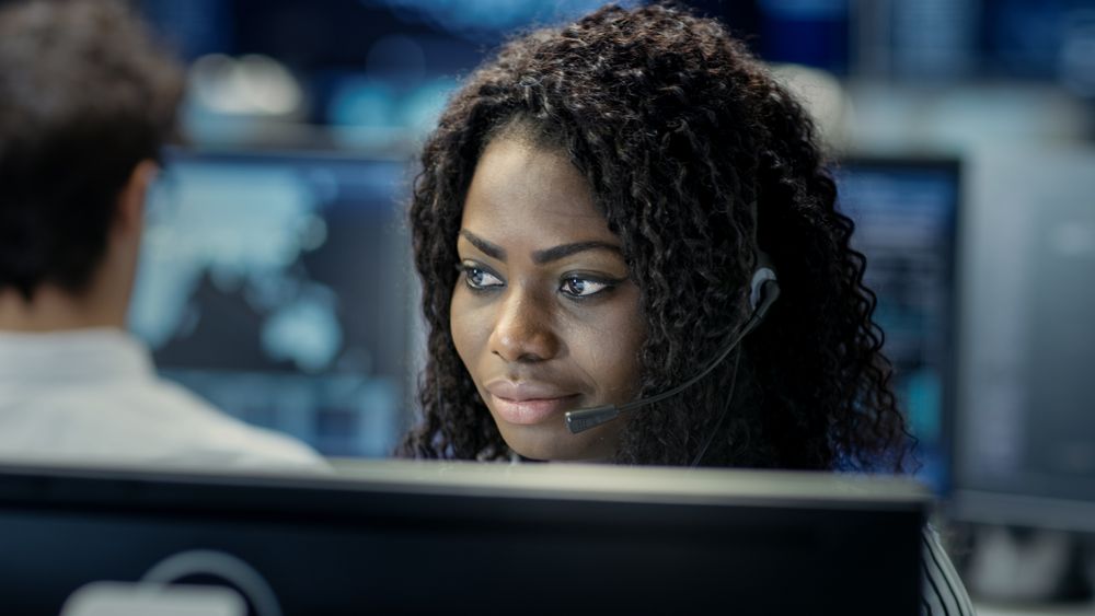 Female Customer Service Representative Answer Client's Questions in a Headset.