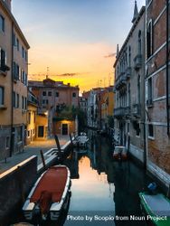Water canal between buildings in Venice, Italy during sunset  bY6Q10
