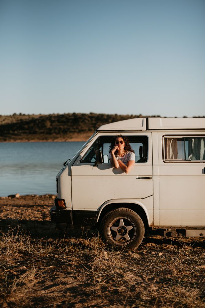 Smiling woman sitting in retro car