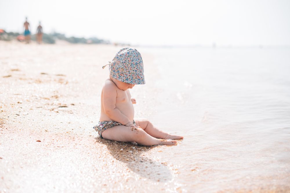 Cute baby sitting on beach