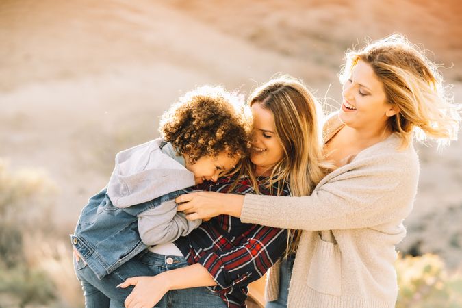 Smiling blond women walking with curly child