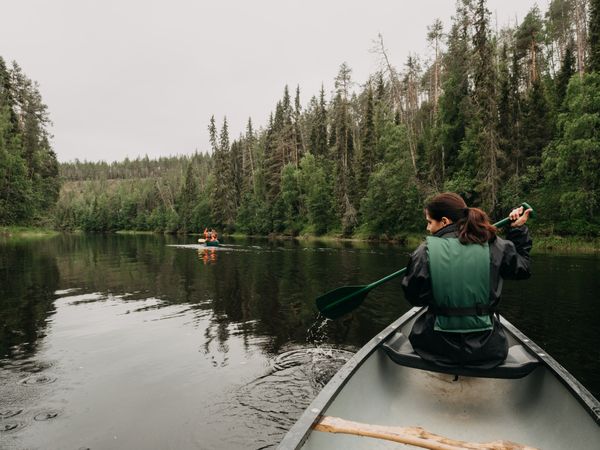 Woman boating on forest river in Finland