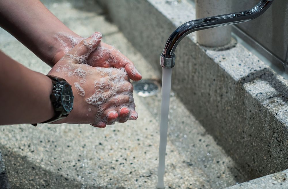 Cropped image of person washing their hands