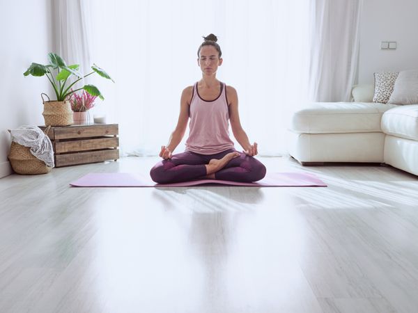 Woman meditating on sunny morning