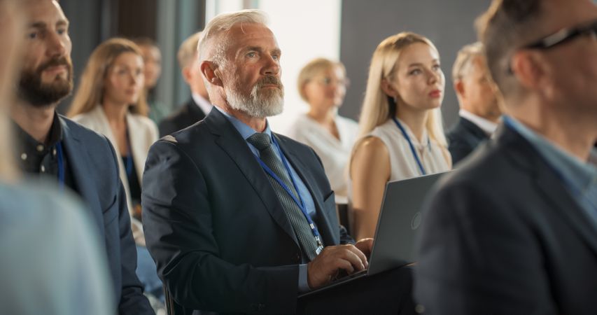 White Man Listening To Keynote Presentation About New Innovative Startup Company Service.
