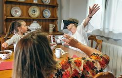 Young woman taking a picture to her mother using virtual reality glasses
