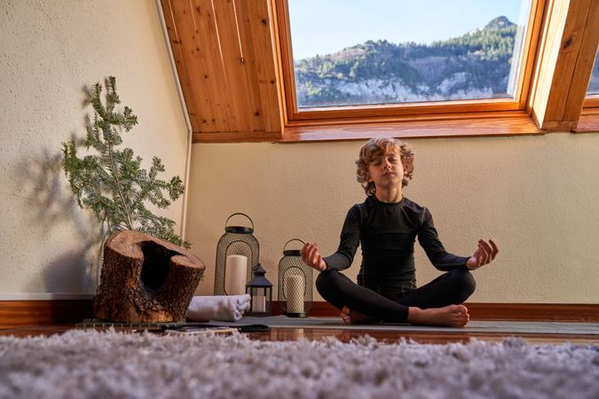 Child meditating in lotus pose