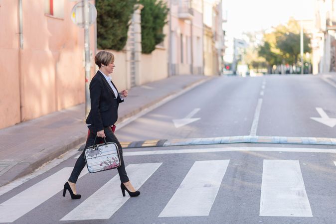 Well dressed woman crossing the street