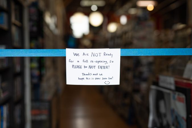 Hand written sign hanging across store entrance