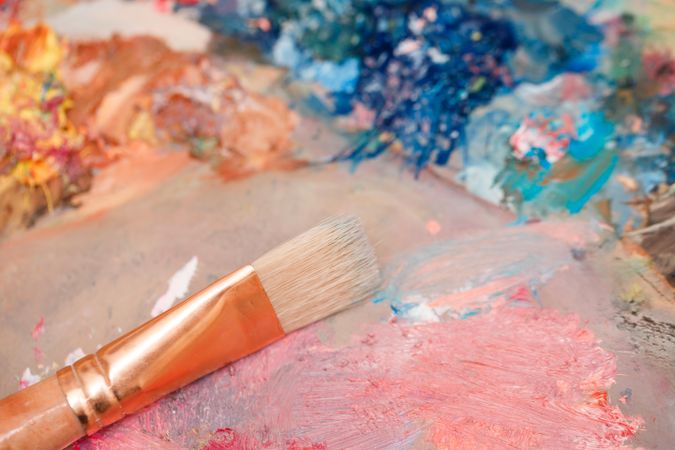 Paint brush lying on paint palette