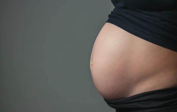 Belly of pregnant woman in profile