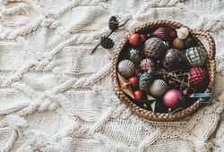 Christmas glass festive decoration toys and balls in basket, top view, copy space