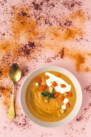 Orange vegetable cream with slices of carrots and herbs