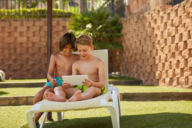 Boys using tablet in garden