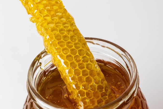 Honey with honeycomb in glass jar